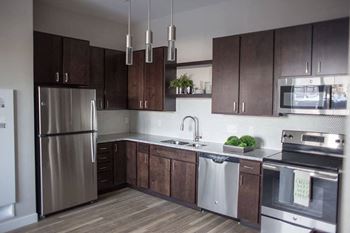 A kitchen with wooden cabinets